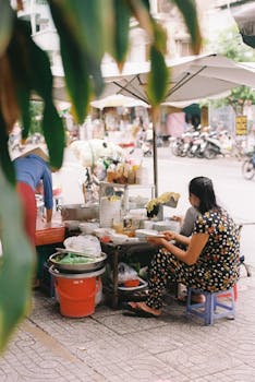 A street food vendor in Ho Chi Minh City captured in candid daytime setting.