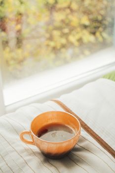 Warm cup of tea by a window on an autumn morning in Istanbul, evoking cozy vibes.