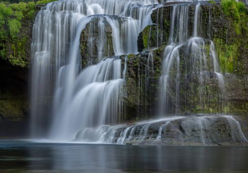 Free Stunning view of a cascading waterfall surrounded by lush greenery in Cougar, Washington. Stock Photo
