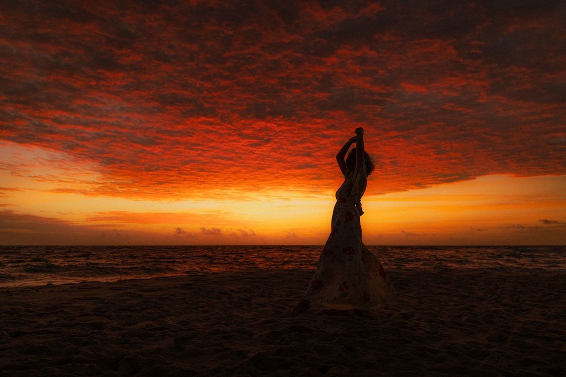 Silhouette Woman Dancing at Sunset on Beach · Free Stock Photo