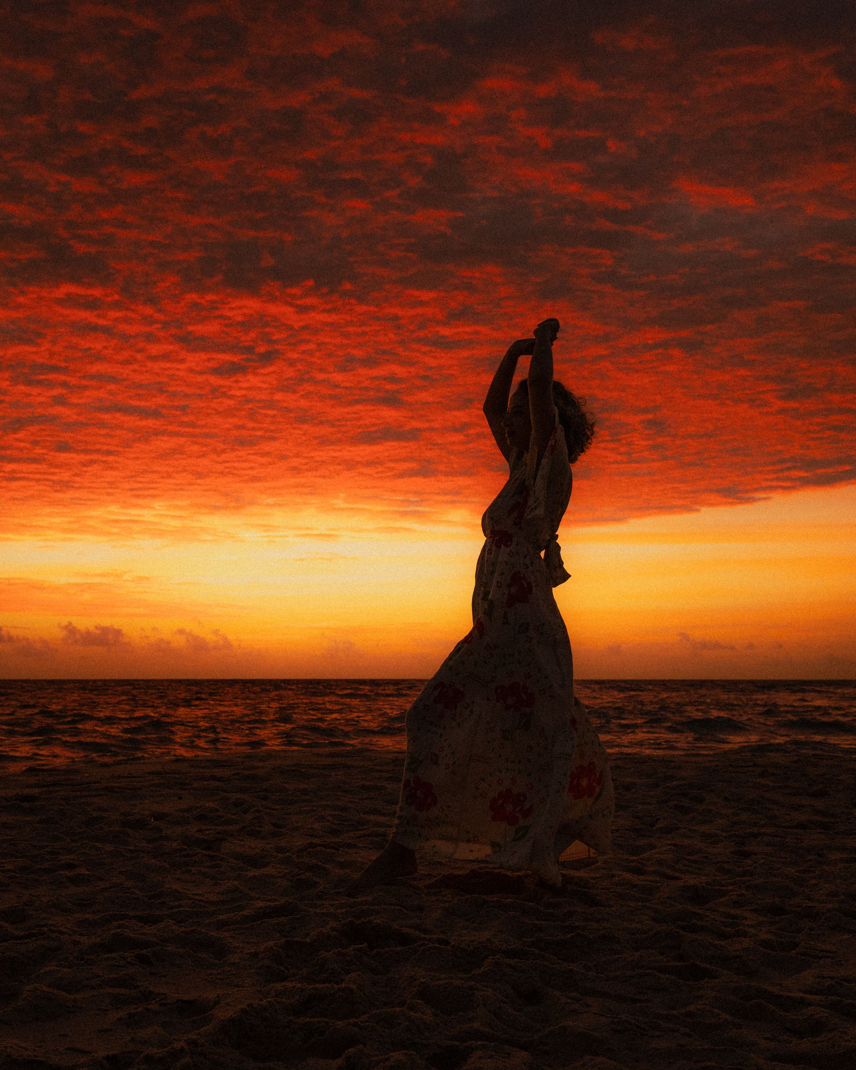 Silhouette of Woman Dancing at Sunset Beach · Free Stock Photo