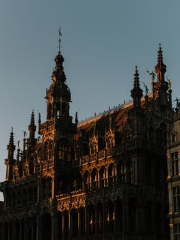 A stunning view of the Grand Place in Brussels during sunset highlighting its gothic architecture.
