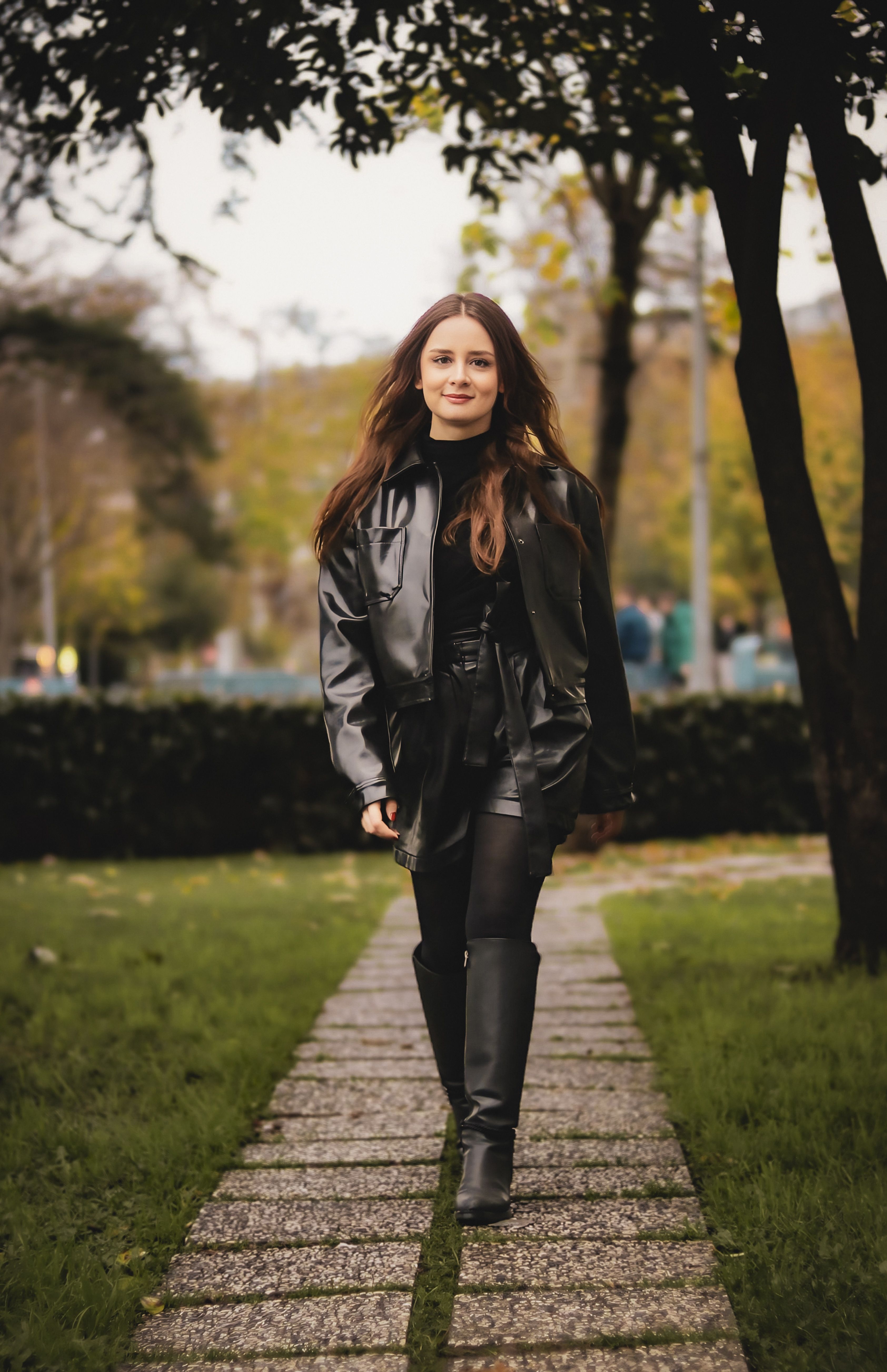 Stylish Woman Walking in Urban Park Setting · Free Stock Photo