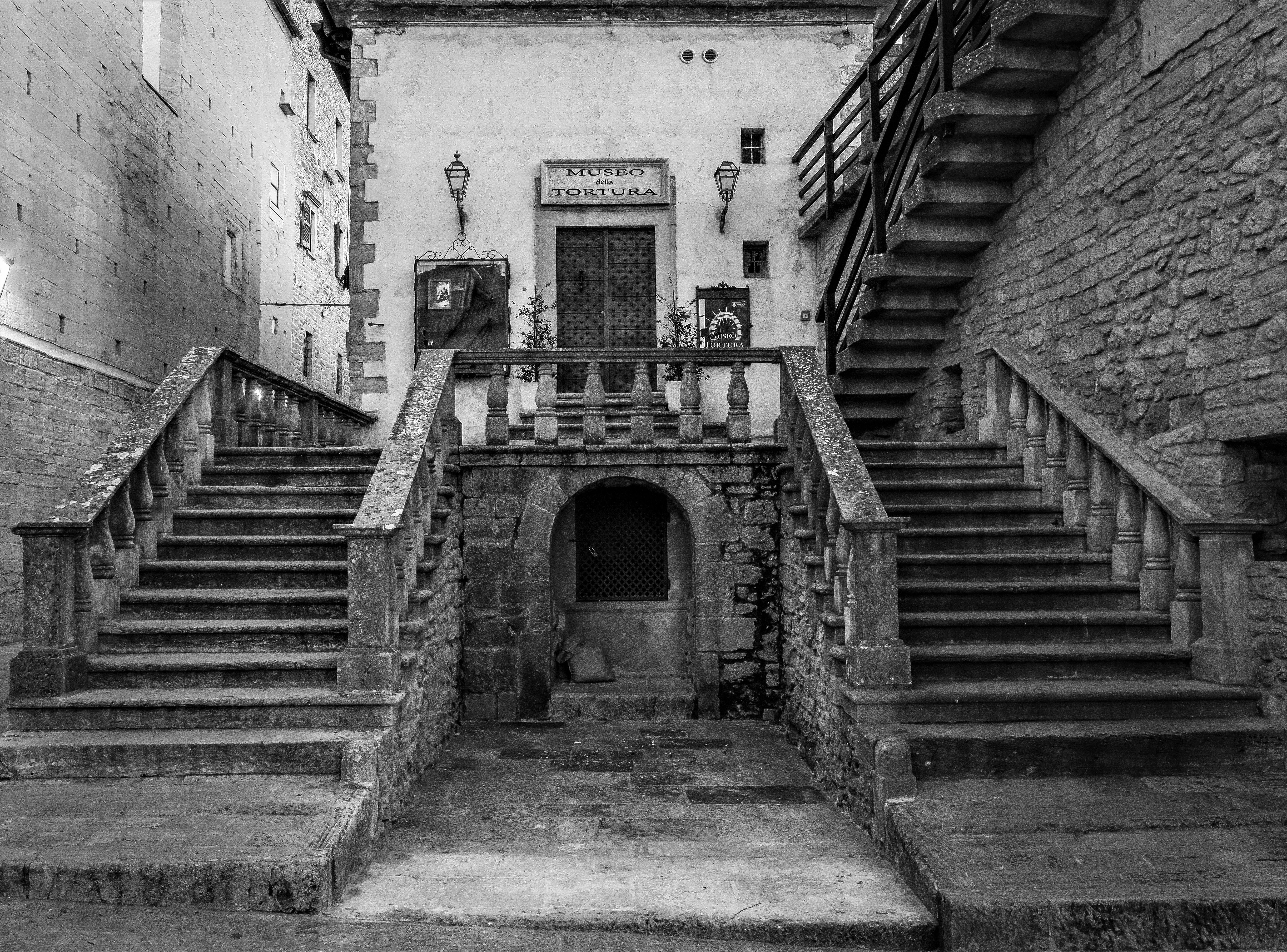 Black and white photo of a historic stone staircase and building facade.