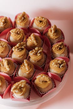 Indulge in delightful walnut cupcakes adorned with creamy caramel frosting, perfect for celebrations.