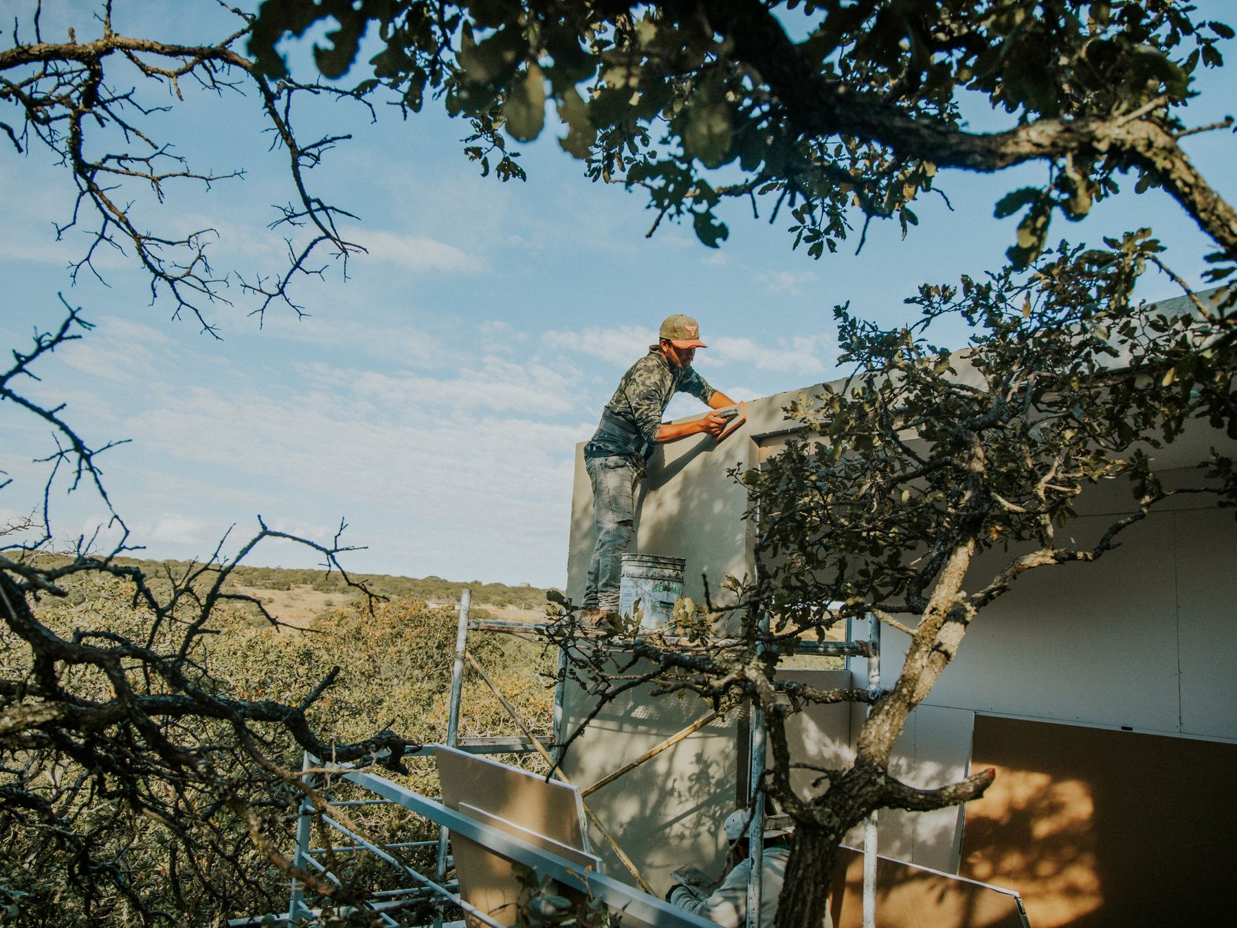 Fence and Decking Painting in Mayfair — a decorator at work mid-project