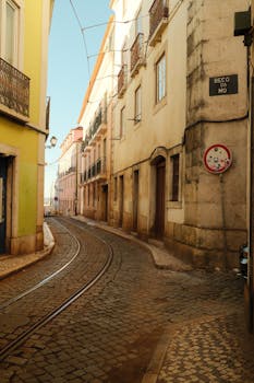 Discover the quaint and historic cobblestone streets of Beco da Mo in Lisbon's picturesque cityscape.