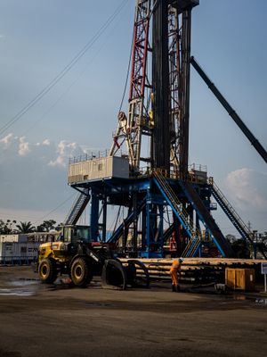 Rig pengeboran darat saat senja di Riau