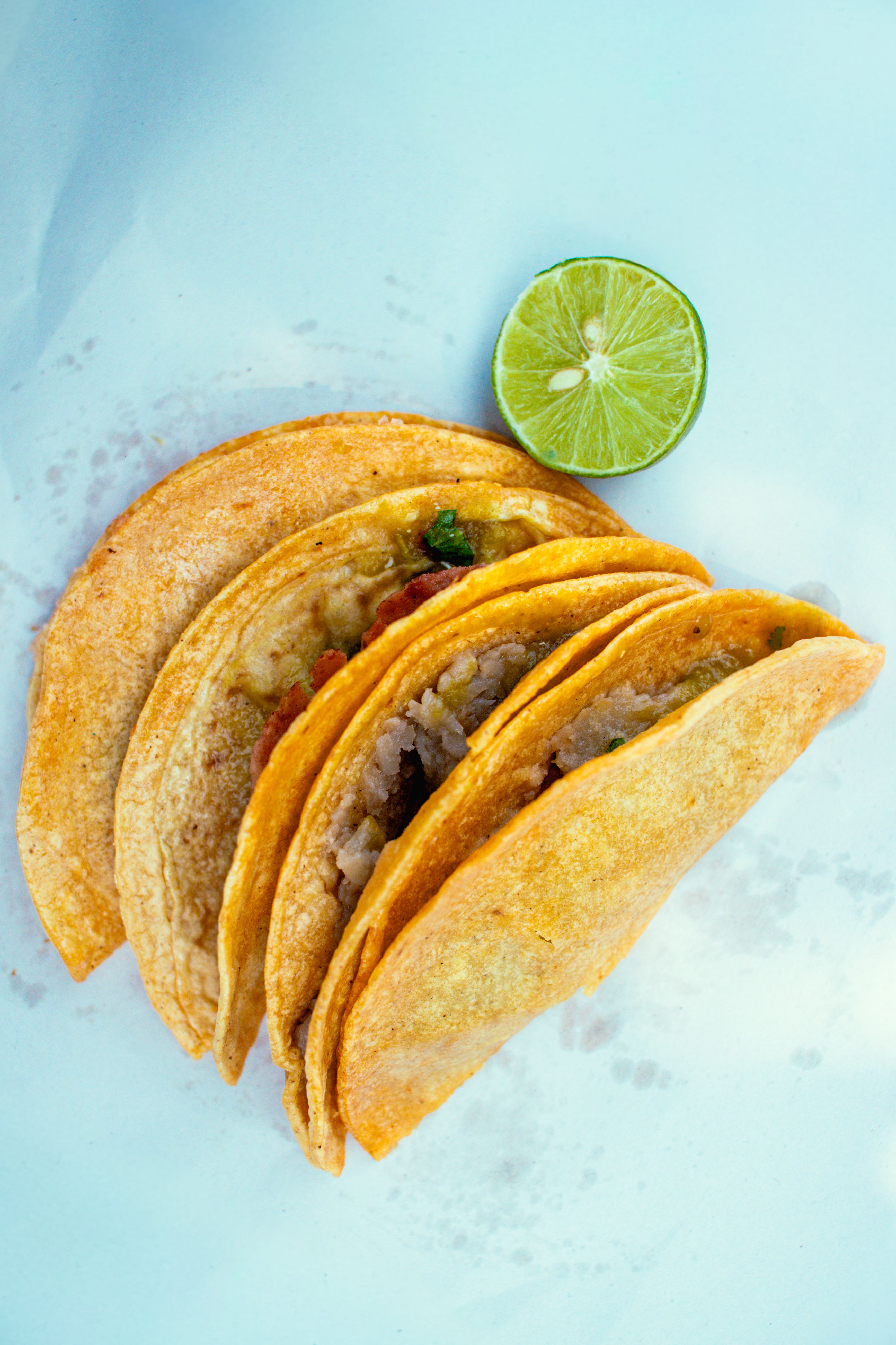 Overhead view of a spread of SHRK's birria tacos served on parchment