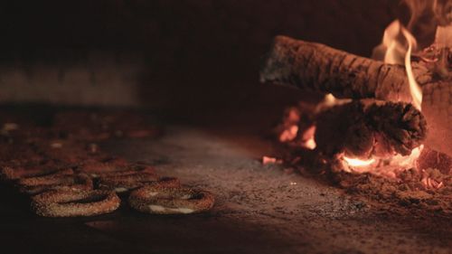 Free Rustic bagels baking in a traditional wood-fired oven with glowing flames. Stock Photo
