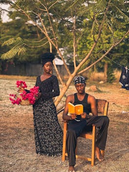 Two adults enjoy a serene outdoor moment with nature and vibrant flowers.