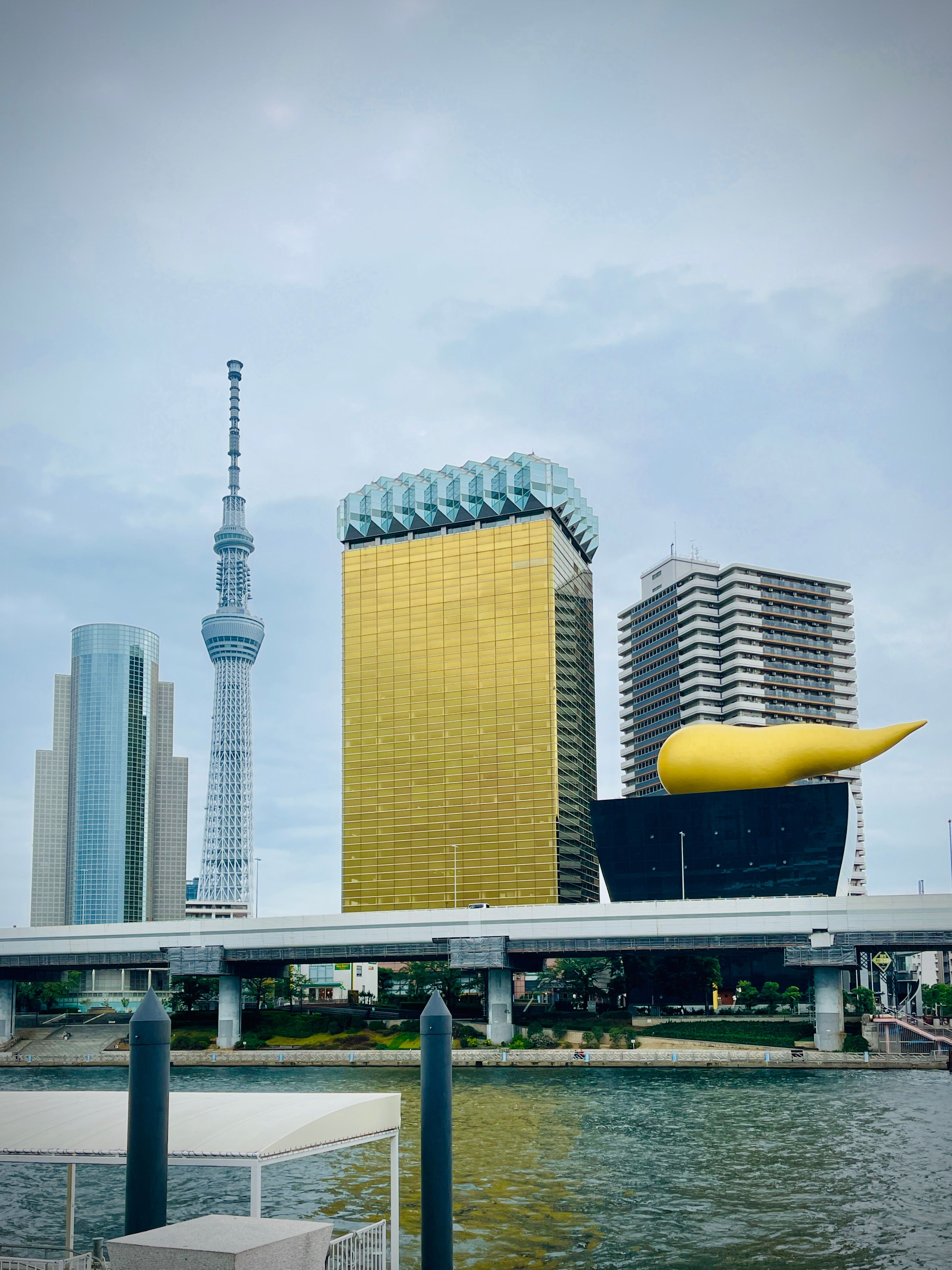 Skyline view featuring Tokyo Skytree and the iconic Asahi Beer Hall building in Tokyo.