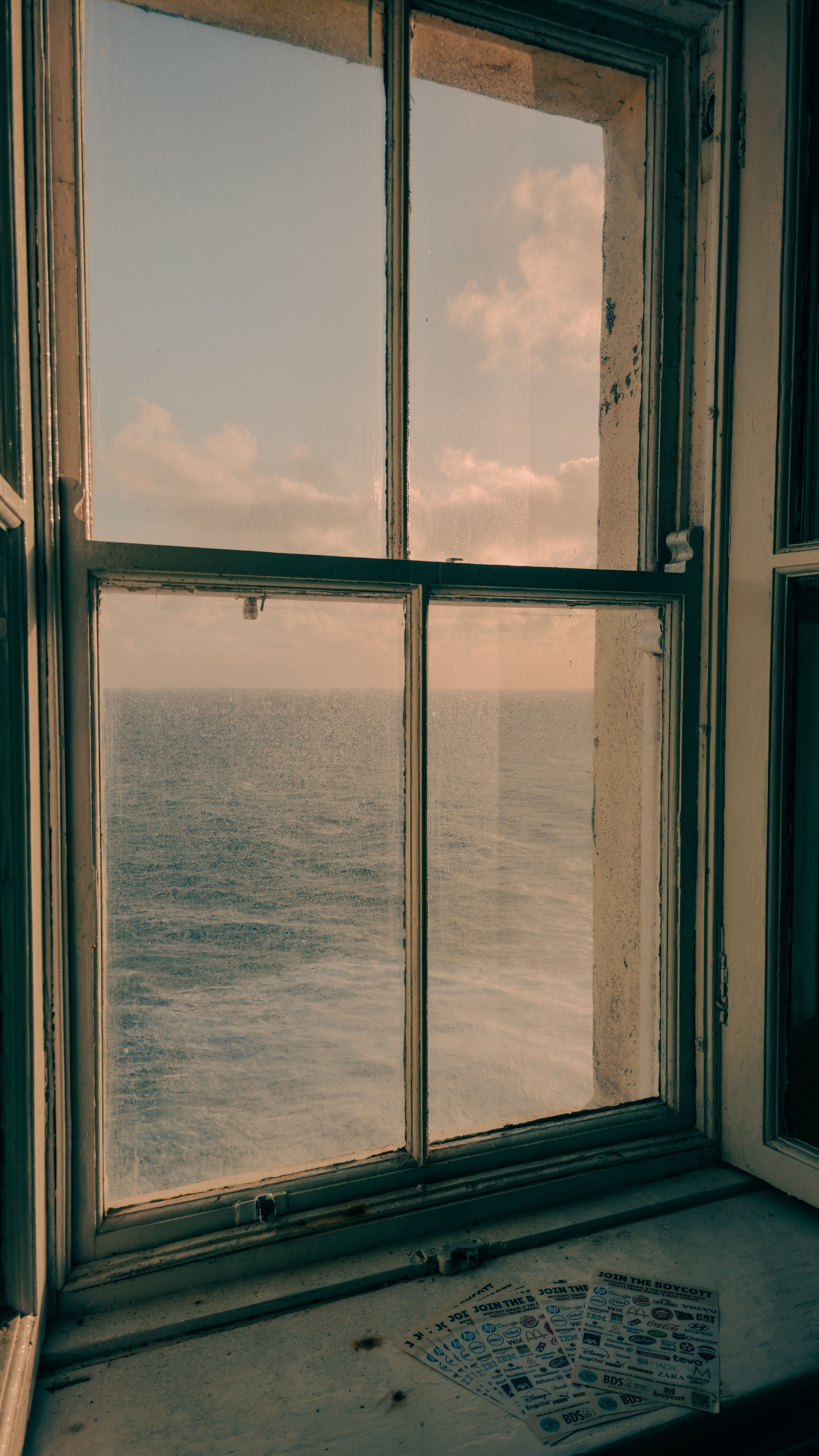 Serene Ocean View Through Rustic Window · Free Stock Photo