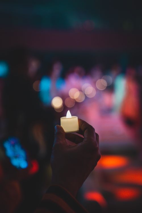 Free Serene candlelight vigil in Jakarta, depicting unity and peace with a soft bokeh background. Stock Photo