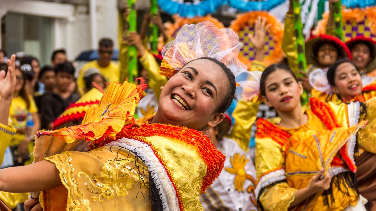 colorful festival parade featuring joyful dancers in traditional costu