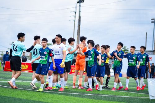 Free Soccer players from two teams exchange handshakes before a match in Hanoi, Vietnam. Stock Photo