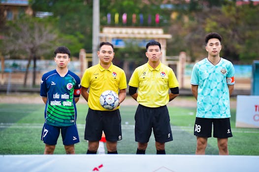 Football players and referees posing before a match in Hanoi, Vietnam.