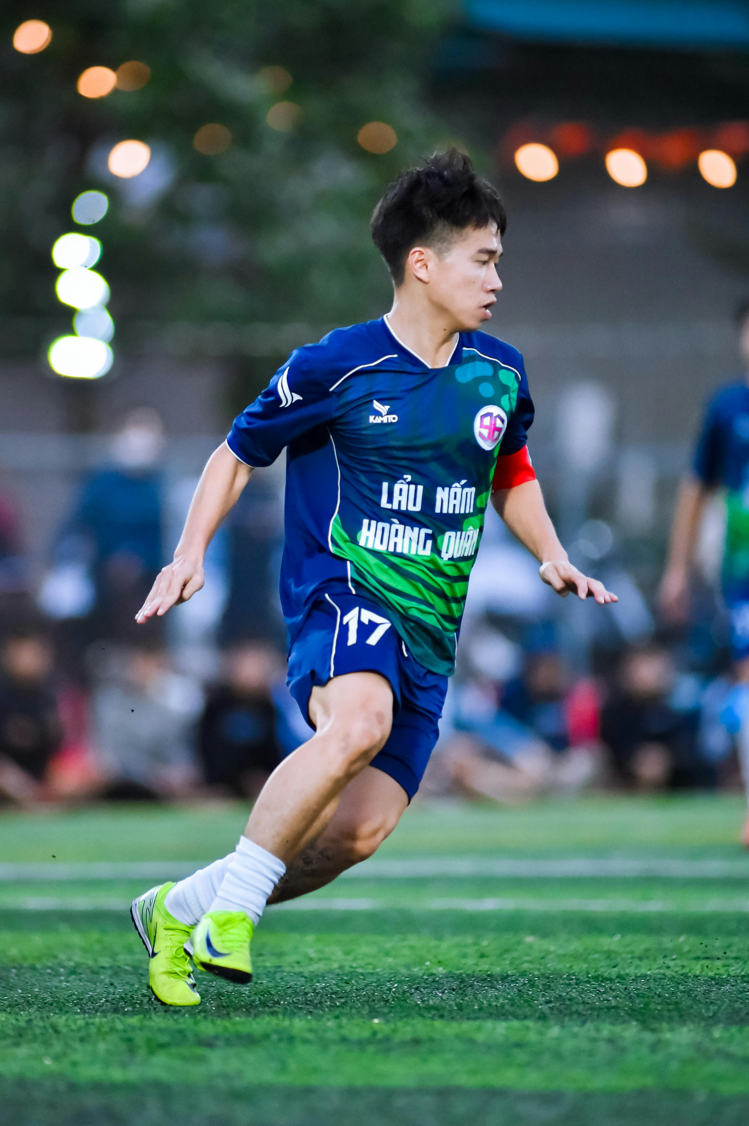 Energetic football player on the field in Hà Nội, showcasing athleticism and focus.