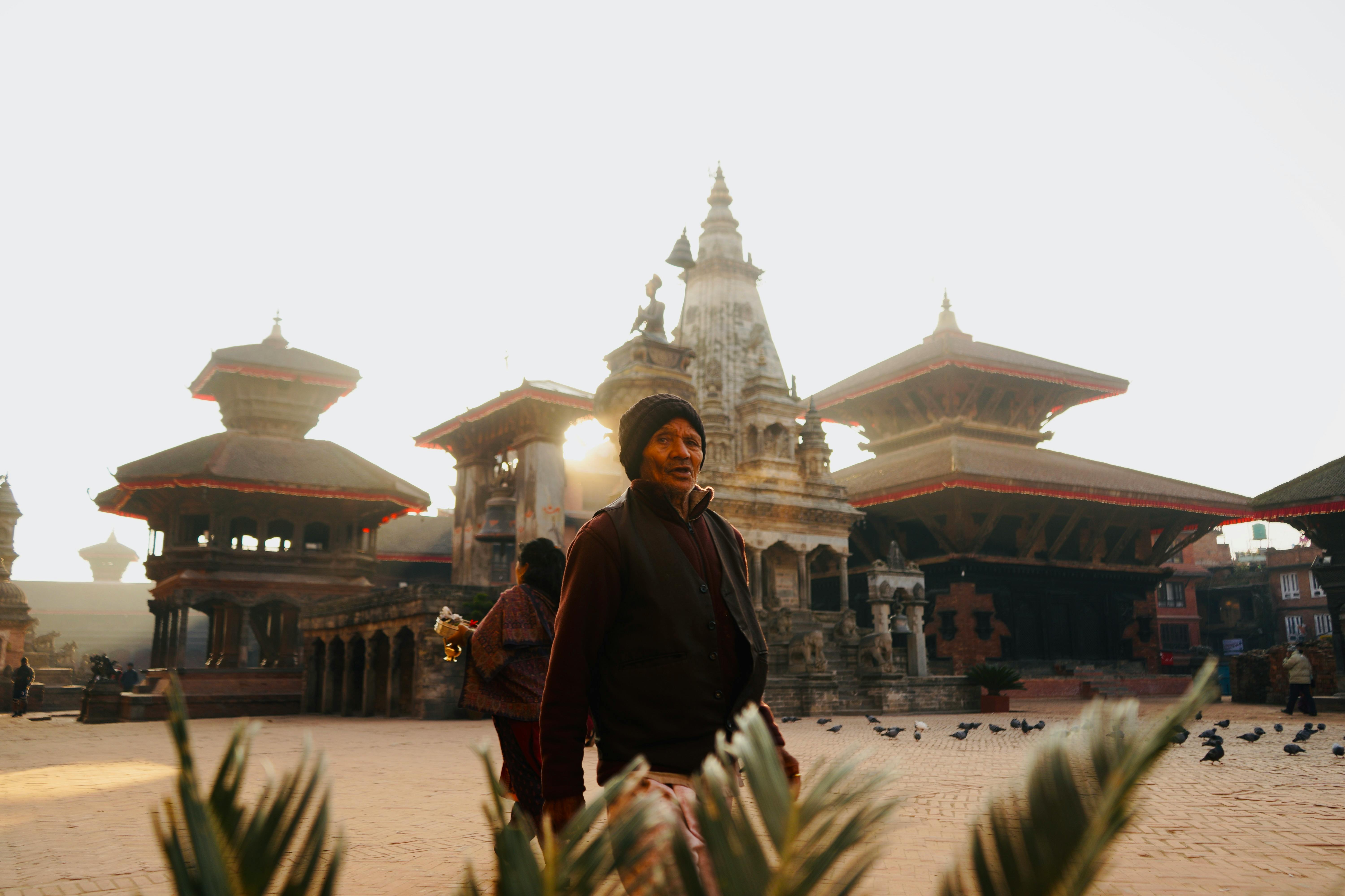 Newar Buddhist monk conducting morning ritual prayers at a Kathmandu Valley courtyard stupa