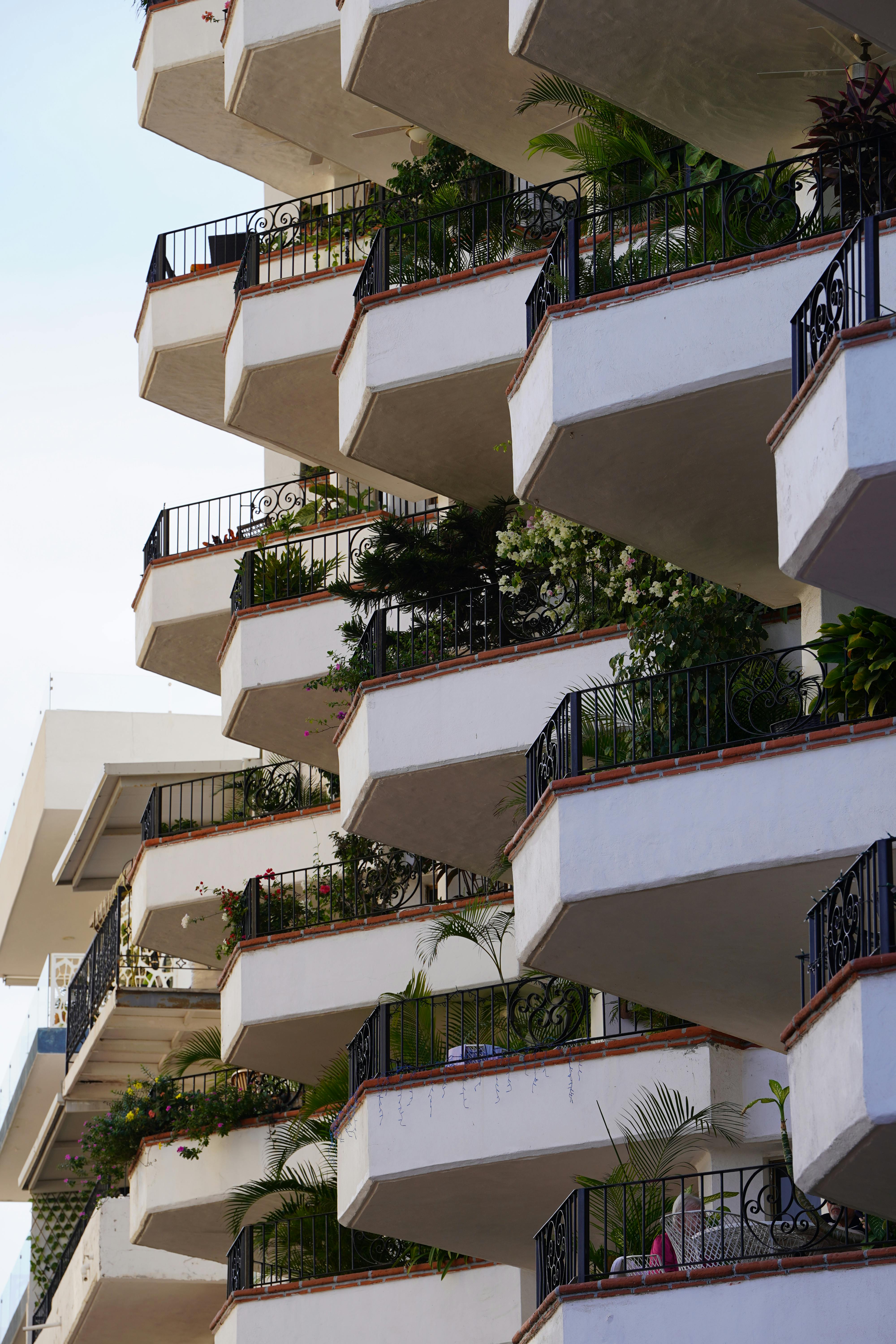 A series of charming balconies adorned with lush greenery in Puerto Vallarta, Mexico.