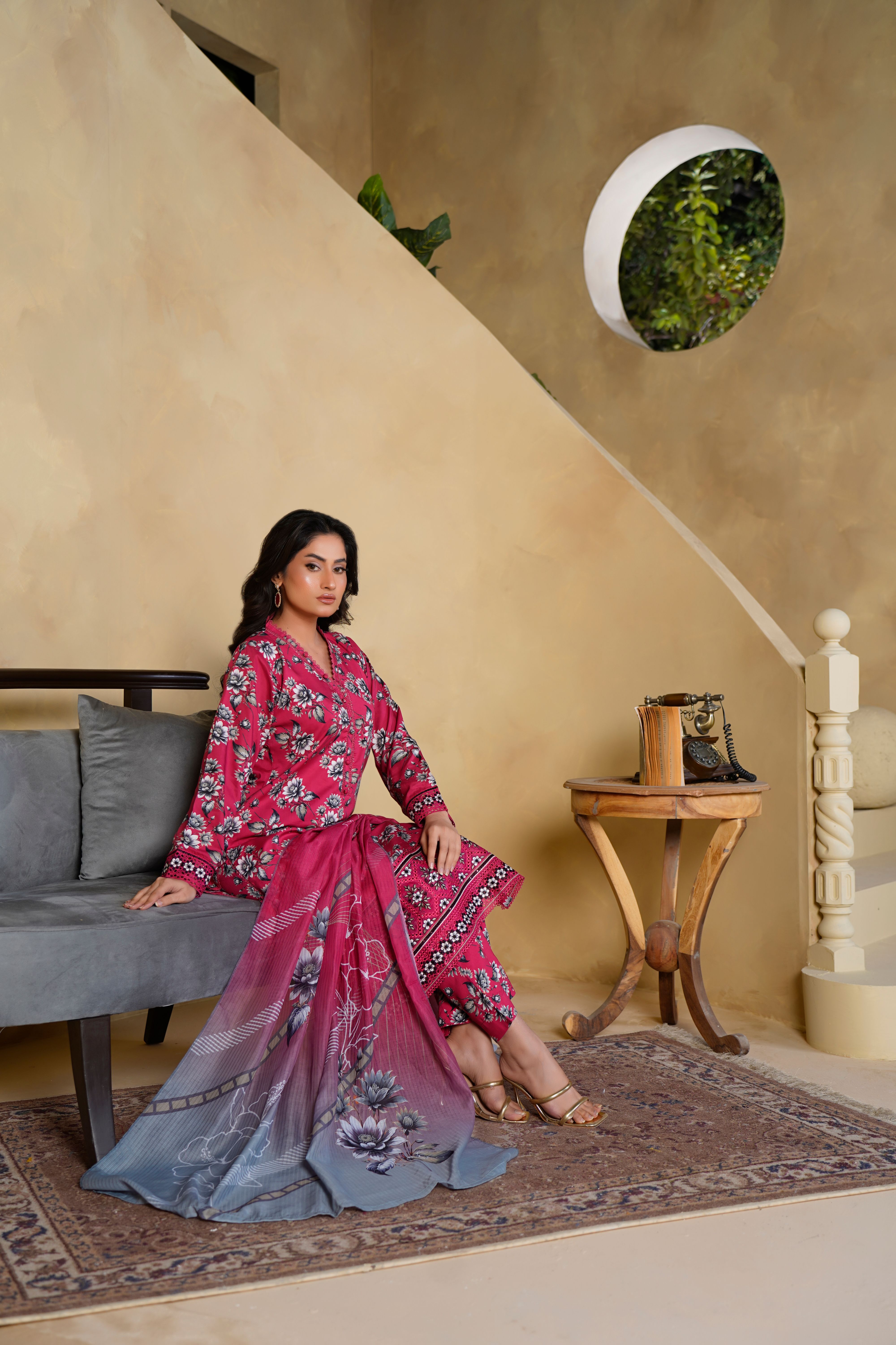 Elegant Woman in Floral Dress Seated Indoors · Free Stock Photo