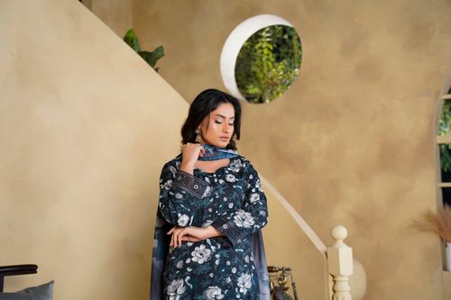 Free Charming portrait of a woman in a floral dress, captured indoors in Lahore, Pakistan. Stock Photo