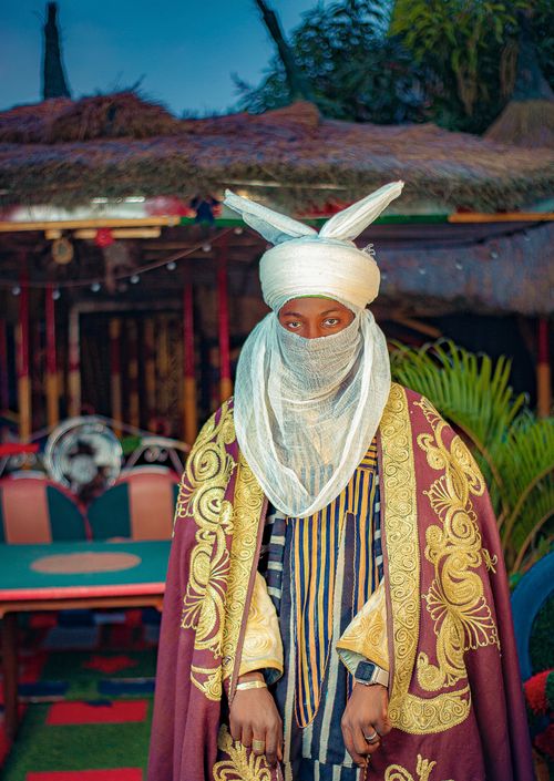 Free A man in intricate traditional clothing and head cover poses indoors, exuding cultural richness. Stock Photo