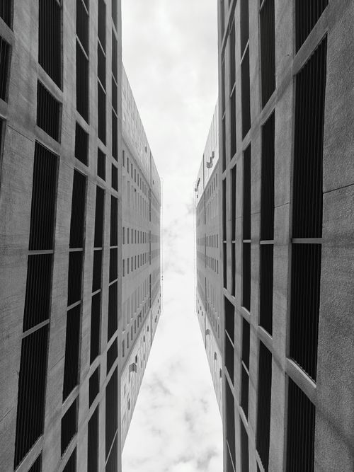 Free Black and white photo of symmetrical high-rise buildings in Sharjah, UAE. Stock Photo