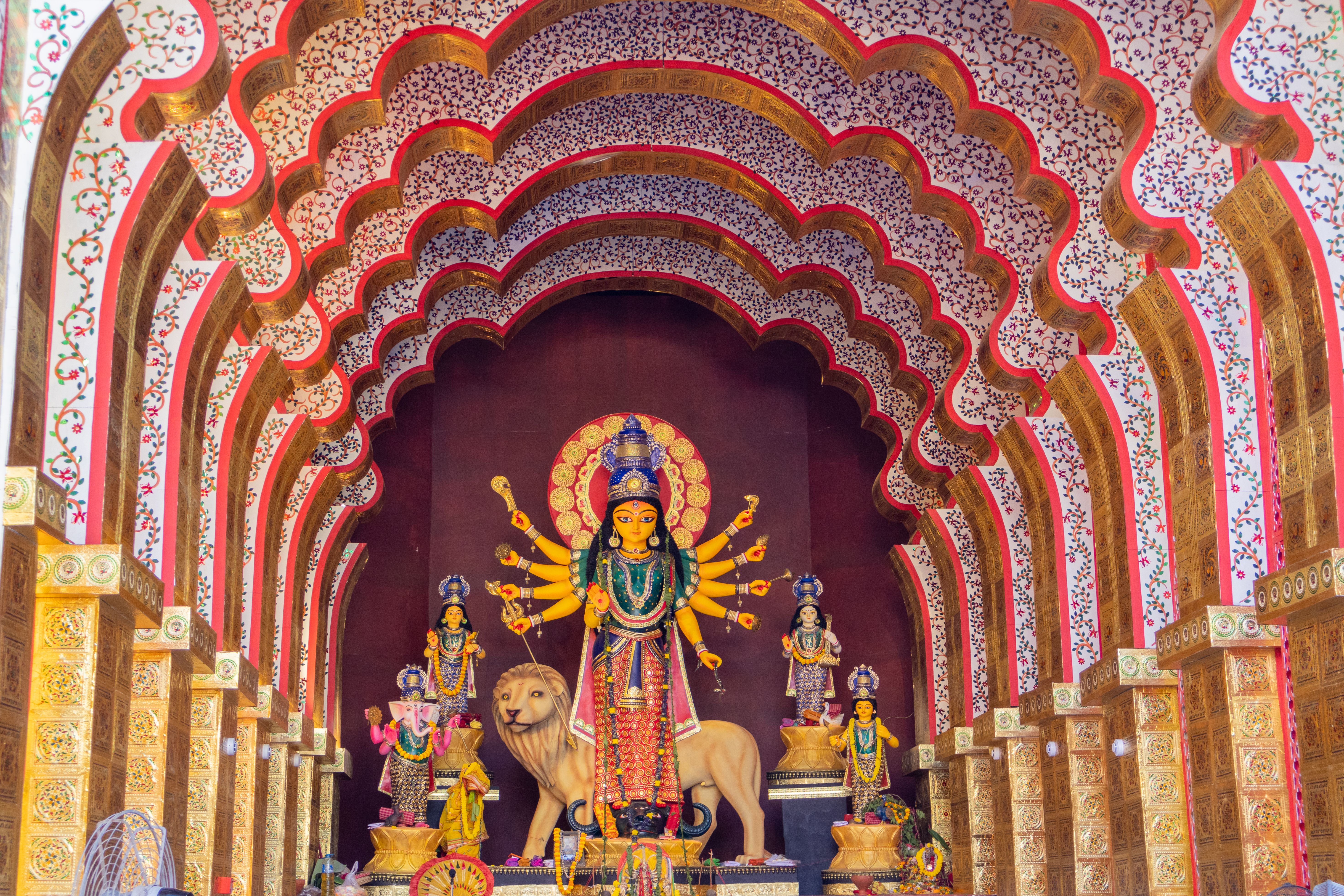 Illuminated Durga Puja pandal at night in a Gurugram sector park