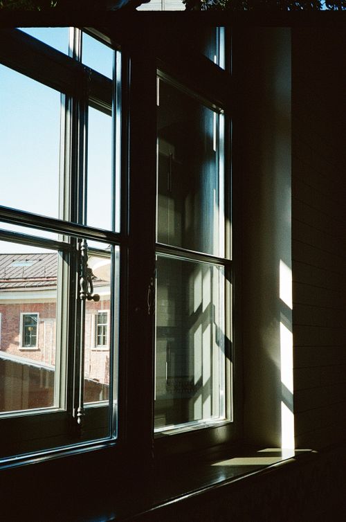 Free Sunlight casts shadows through a window onto walls indoors in Saint Petersburg, Russia. Stock Photo