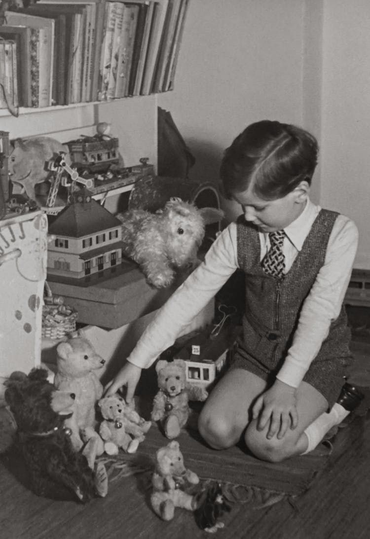 Grayscale Photography Of Toddler Playing Bear Toys