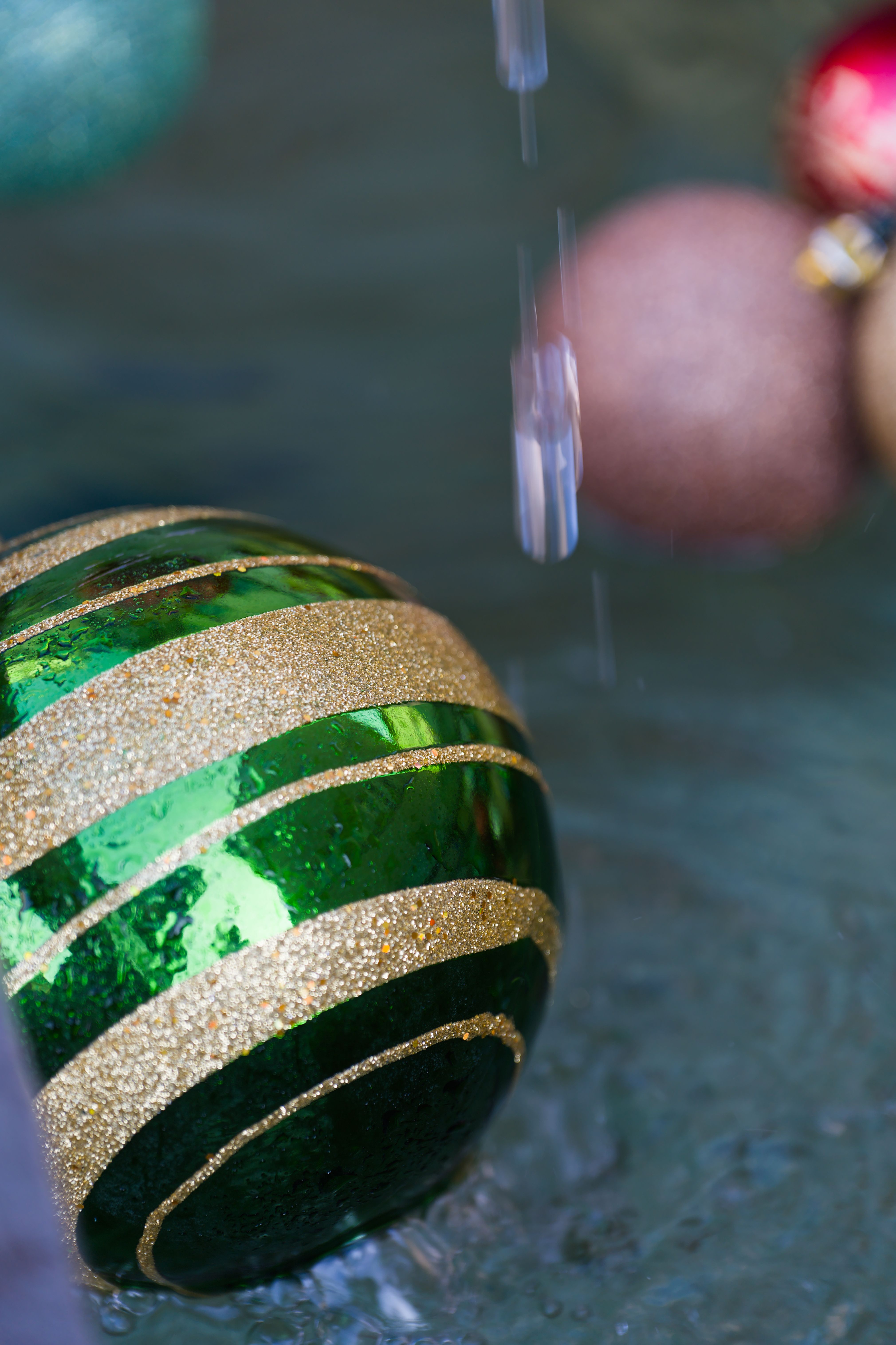 Colorful Christmas ornaments submerged in water, capturing the festive holiday spirit.