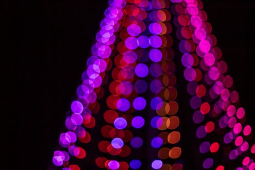 Colorful and festive bokeh lights create a vibrant holiday atmosphere.