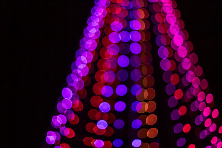 Colorful and festive bokeh lights create a vibrant holiday atmosphere.