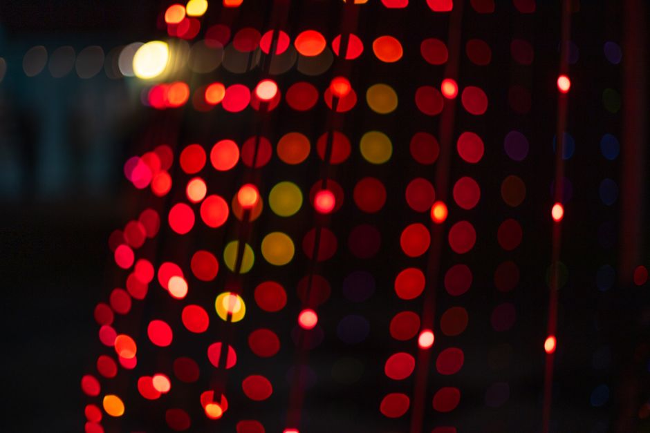 Vivid blurred bokeh lights in red and orange creating a warm, festive atmosphere.