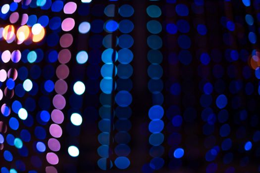 Colorful and vibrant bokeh of festive lights creating a warm, blurred background.