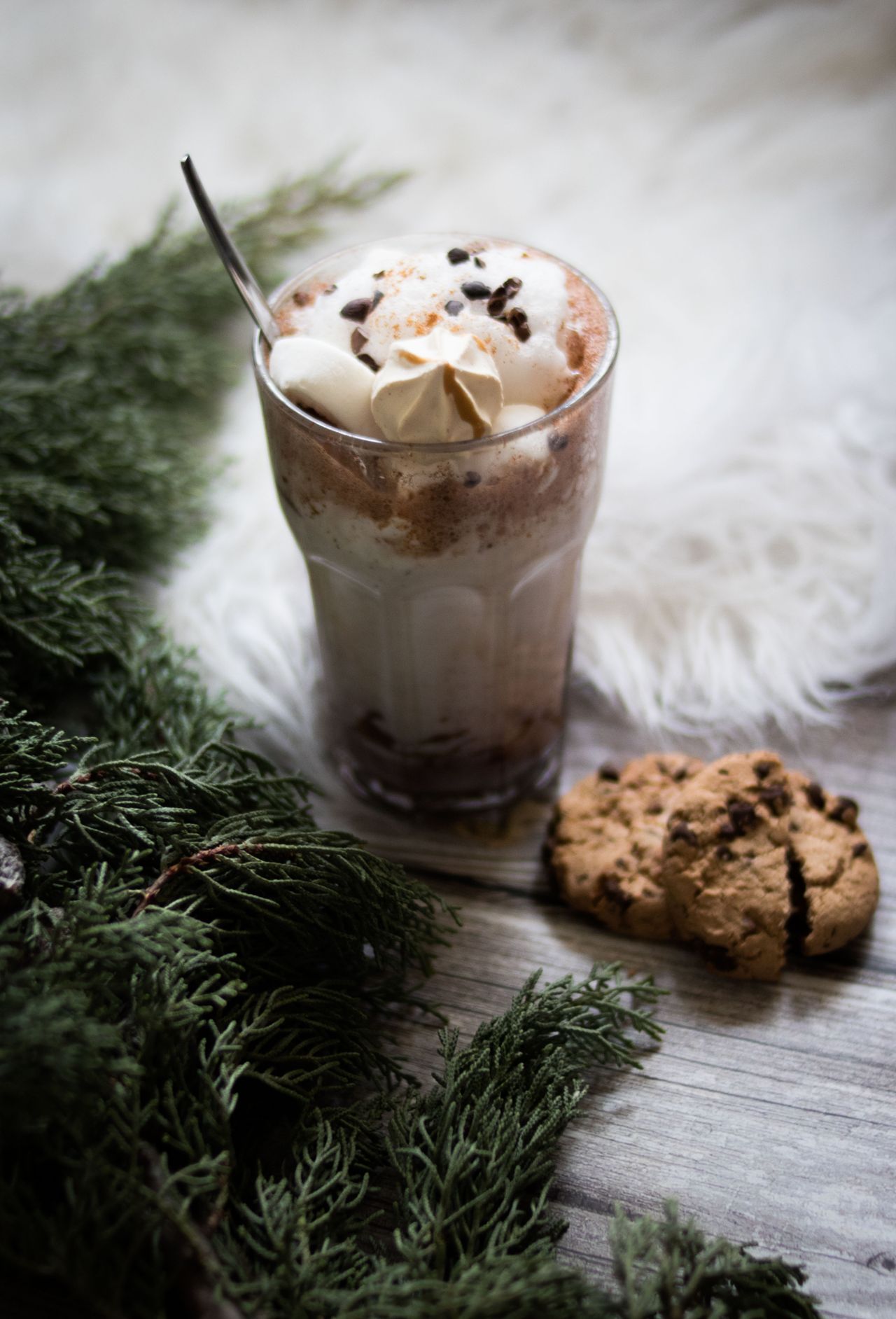 Hot chocolate with whipped cream served with chocolate chip cookies