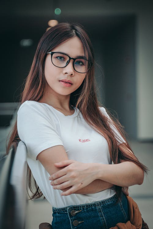 Free Woman Wearing Black Eyeglasses While Crossing Her Arms Stock Photo