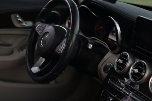 Free Close-up of elegant car dashboard and steering wheel showcasing luxury interior design. Stock Photo