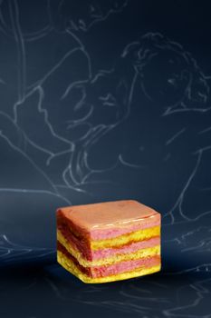Colorful layered cake with artistic outline backdrop, modern appeal.