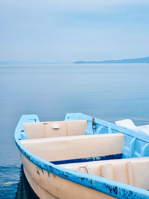 Peaceful view of a boat on Lake Victoria in Homa Bay, Kenya, with serene blue waters.