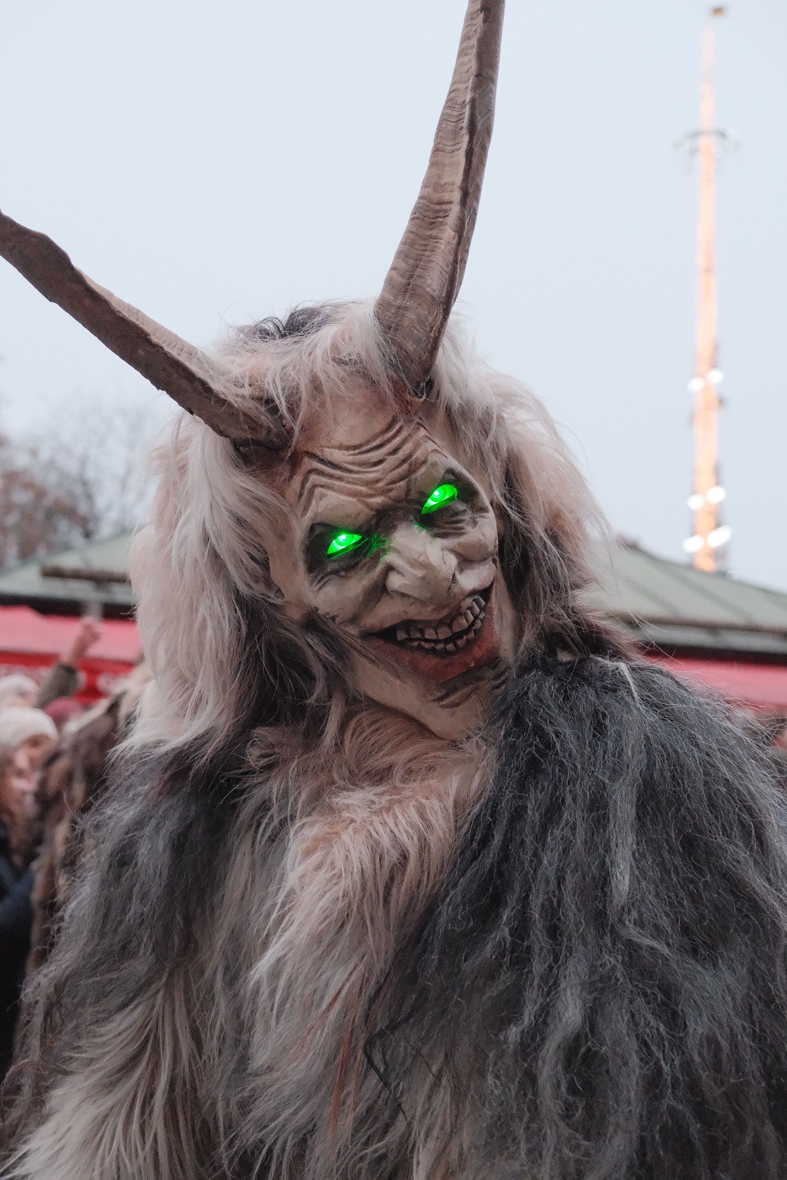 A Krampus figure with glowing eyes in a traditional Bavarian parade in Munich, Germany.