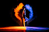 Dynamic Dancer Embracing Colorful Powder Burst