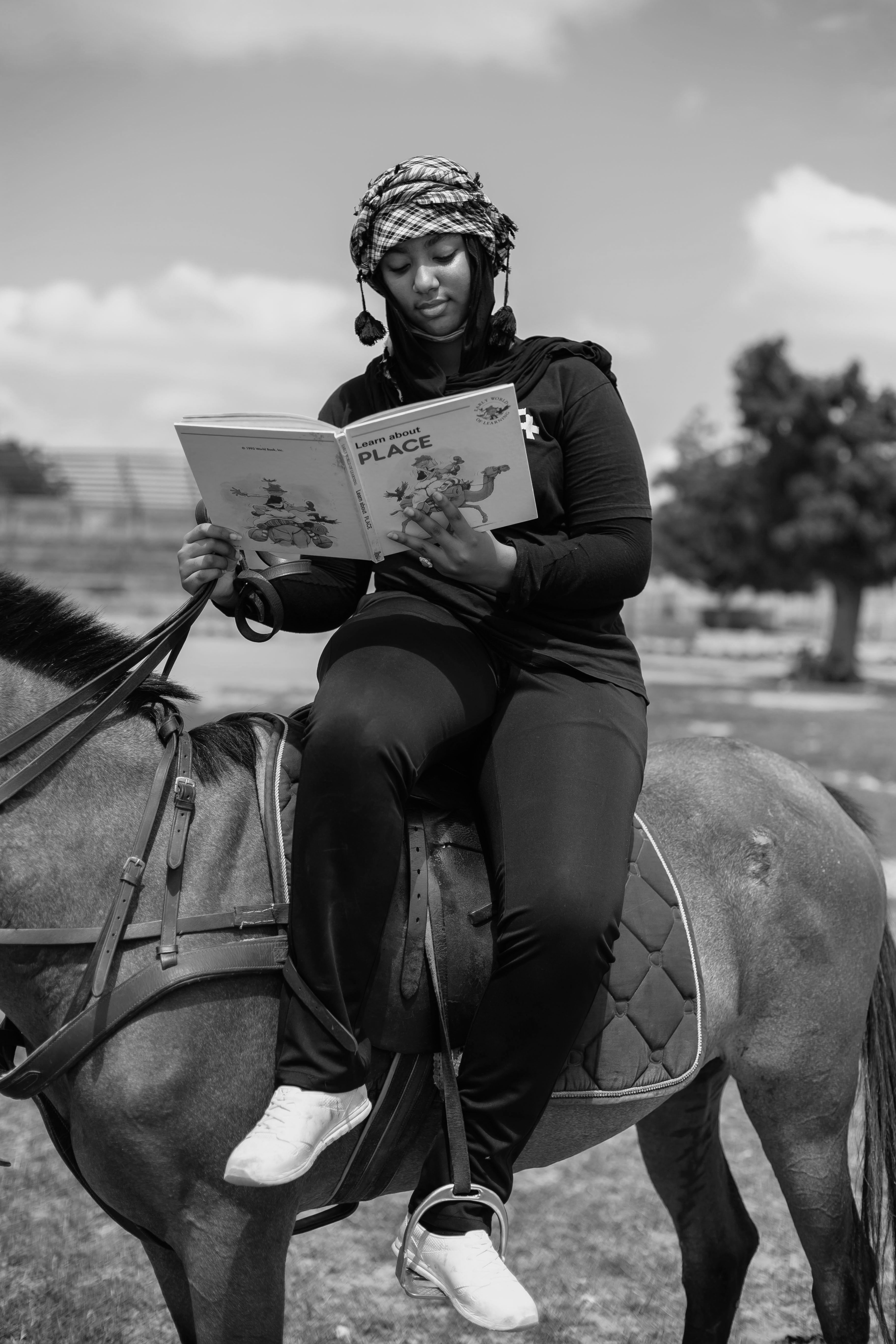 Woman Reading on Horseback in Rural Setting · Free Stock Photo