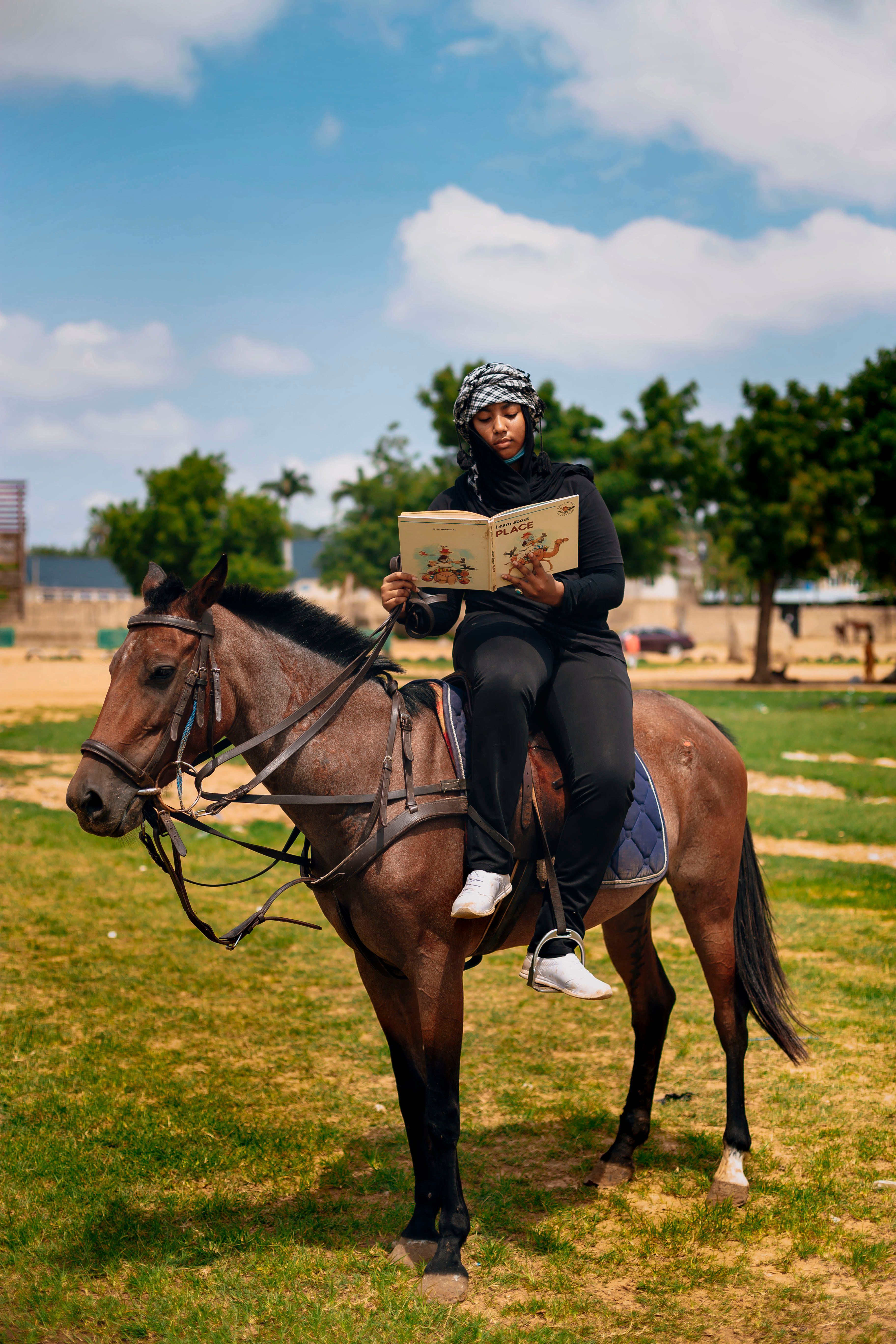 Woman Reading Book on Horse Outdoors · Free Stock Photo