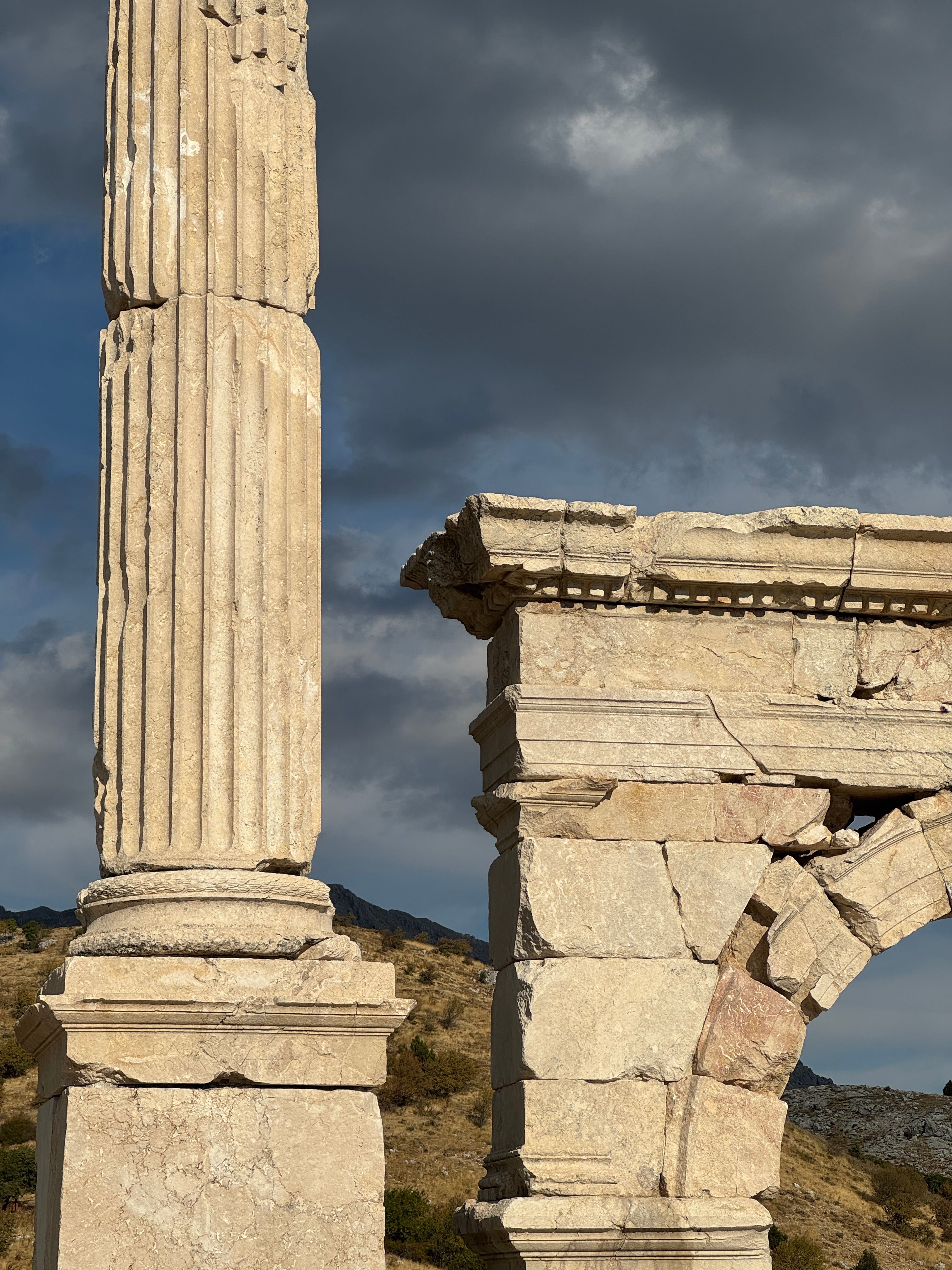 Ancient Stone Columns under Dramatic Sky · Free Stock Photo