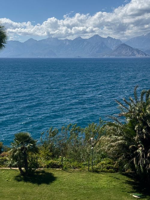 Free Breathtaking view of the Mediterranean Sea and distant mountains under a bright sky. Stock Photo