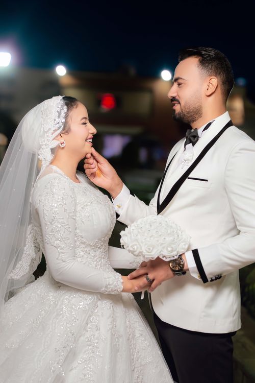 Free Bride and groom sharing a romantic moment outdoors at night. Stock Photo