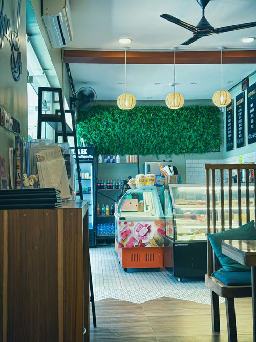 Free Inviting cafe in Dar es Salaam featuring a colorful ice cream fridge and stylish decor. Stock Photo