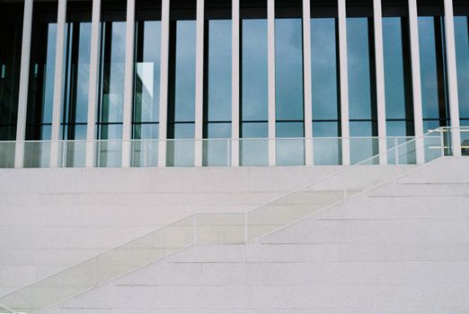 Symmetrical view of a modern building's glass façade with minimalistic design details.